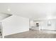 Bright, open living space featuring wood-look floors, recessed lighting, and seamless flow to the kitchen at 571 Homestead Ave, Brighton, CO 80601