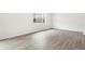 Light-filled living space showcasing stylish wood-look flooring and natural light at 571 Homestead Ave, Brighton, CO 80601