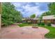 Beautiful backyard with a fire pit, grass, trees, and privacy fence at 3544 Dyanna Dr, Thornton, CO 80241