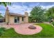 Backyard featuring a brick fire pit and green lawn at 3544 Dyanna Dr, Thornton, CO 80241
