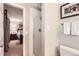 Bathroom view with glass enclosed shower stall, toilet and bedroom doorway view at 3544 Dyanna Dr, Thornton, CO 80241