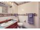 Full bathroom with a single sink vanity, toilet, decorative wallpaper and matching towels at 3544 Dyanna Dr, Thornton, CO 80241