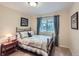 Cozy bedroom with a decorative bed, large window and view of the outdoors at 3544 Dyanna Dr, Thornton, CO 80241