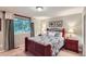 Cozy bedroom with a large window, floral bedding, and matching bedside tables at 3544 Dyanna Dr, Thornton, CO 80241