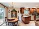 Well-lit kitchen and dining area with wooden cabinets, granite countertops, and stainless steel appliances at 3544 Dyanna Dr, Thornton, CO 80241