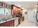 Kitchen with wood cabinets, stainless appliances, and a tile floor at 3544 Dyanna Dr, Thornton, CO 80241