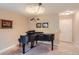 Living room showcasing a black piano under a chandelier at 3544 Dyanna Dr, Thornton, CO 80241