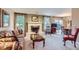 Cozy living room featuring a fireplace and adjacent dining area at 3544 Dyanna Dr, Thornton, CO 80241