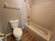 Clean bathroom features a toilet and a bathtub shower combination with tile surround at 14499 E 1St Dr # A05, Aurora, CO 80011