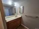 Functional bathroom offering a wood vanity with an integrated sink and mirror at 14499 E 1St Dr # A05, Aurora, CO 80011