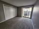 Bedroom with plush carpet, closet with sliding doors, and sliding door to patio at 14499 E 1St Dr # A05, Aurora, CO 80011
