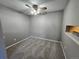 Neutral bedroom featuring carpet, a ceiling fan with light, and grey walls and trim at 14499 E 1St Dr # A05, Aurora, CO 80011