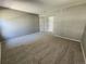 Spacious bedroom featuring neutral walls, carpet, and two entry doors at 14499 E 1St Dr # A05, Aurora, CO 80011