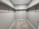 Walk-in closet with carpet and metal hanging rods ready to organize clothes and accessories at 14499 E 1St Dr # A05, Aurora, CO 80011