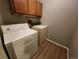 Convenient laundry room featuring a washer, dryer, and storage cabinets at 14499 E 1St Dr # A05, Aurora, CO 80011
