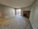 Comfortable living room with a brick fireplace, carpet, and sliding glass doors to the patio at 14499 E 1St Dr # A05, Aurora, CO 80011