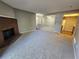 Cozy living room featuring a brick fireplace, carpet, and an open floor plan at 14499 E 1St Dr # A05, Aurora, CO 80011