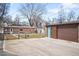The property has a detached garage, with a fenced backyard, and a cozy brick house at 2686 S Gilpin St, Denver, CO 80210