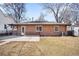 The home has a well-maintained brick exterior, a cozy patio, and a grassy backyard at 2686 S Gilpin St, Denver, CO 80210