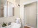 Neat bathroom featuring a sink, mirrored cabinet, and a clean, neutral color scheme at 2686 S Gilpin St, Denver, CO 80210
