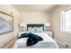 Beautifully designed bedroom with an upholstered headboard, two side tables, and a cozy blanket creating a relaxing ambiance at 2686 S Gilpin St, Denver, CO 80210