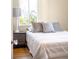 Bright bedroom featuring a large window and a cozy bedside setup with stylish lamps and pillows at 2686 S Gilpin St, Denver, CO 80210