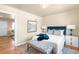 Comfortable bedroom with a stylish bench, hardwood floors, and an inviting atmosphere perfect for relaxation at 2686 S Gilpin St, Denver, CO 80210