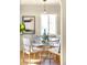Sunlit dining room featuring a glass-top table, modern chairs, and stylish decor at 2686 S Gilpin St, Denver, CO 80210