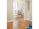 Bright dining room with hardwood floors, modern lighting, and a glass table set for four at 2686 S Gilpin St, Denver, CO 80210