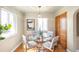 Well-lit dining room with hardwood floors, modern lighting, and a glass table, perfect for entertaining at 2686 S Gilpin St, Denver, CO 80210