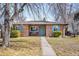 Charming brick home featuring a manicured front yard, blue shutters, and an inviting walkway at 2686 S Gilpin St, Denver, CO 80210