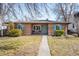 Beautiful brick home featuring a classic design, blue accents, and a welcoming front yard, perfect for families at 2686 S Gilpin St, Denver, CO 80210