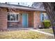 Charming brick home with a welcoming front porch and well-manicured landscaping at 2686 S Gilpin St, Denver, CO 80210