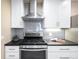 Modern kitchen with sleek white cabinets, stainless steel appliances, and stylish gray backsplash at 2686 S Gilpin St, Denver, CO 80210
