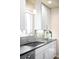 Charming kitchen features gray backsplash, stainless steel sink, and white cabinetry for a modern, clean aesthetic at 2686 S Gilpin St, Denver, CO 80210