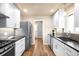Updated kitchen featuring white cabinets, stainless steel appliances, and modern backsplash at 2686 S Gilpin St, Denver, CO 80210