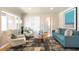 Bright living room with hardwood floors, neutral paint, blue sofa, and large windows providing natural light at 2686 S Gilpin St, Denver, CO 80210