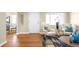 Inviting living room with hardwood floors, comfortable chairs, and an arched doorway leading to the dining room at 2686 S Gilpin St, Denver, CO 80210