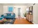 Modern living room featuring hardwood floors, neutral walls, a blue sofa, and stylish decor at 2686 S Gilpin St, Denver, CO 80210