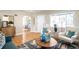 Cozy living room with hardwood floors, an arched doorway, and large windows for ample natural light at 2686 S Gilpin St, Denver, CO 80210