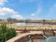 Charming backyard patio seating overlooking a tranquil pond and open fields at 12431 Red Fox Way, Broomfield, CO 80021