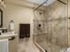 Comfortable bathroom featuring a seated glass shower with decorative tile, vanity, and towel rack at 12431 Red Fox Way, Broomfield, CO 80021