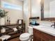 Stylish powder room featuring wood accents, sleek fixtures, floating shelves, and modern decor at 12431 Red Fox Way, Broomfield, CO 80021