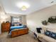 Comfortable bedroom with a wooden bed frame, couch, and natural light at 12431 Red Fox Way, Broomfield, CO 80021