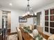 Sophisticated dining room featuring a long wooden table with decorative accents and a stylish chandelier at 12431 Red Fox Way, Broomfield, CO 80021