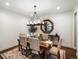 Elegant dining room featuring hardwood floors, table with seating for six, chandelier and decor at 12431 Red Fox Way, Broomfield, CO 80021