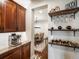 Charming dining area with wood cabinets, granite countertops, decorative shelving, and an espresso machine at 12431 Red Fox Way, Broomfield, CO 80021