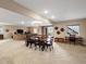 Open-concept dining area with a large wooden table and seating for eight at 12431 Red Fox Way, Broomfield, CO 80021