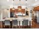 Kitchen boasts wood cabinets, granite countertops, an island with seating, and modern lighting fixtures at 12431 Red Fox Way, Broomfield, CO 80021