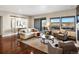 Bright, spacious living room featuring a comfortable sectional sofa, large windows, and a serene outdoor view at 12431 Red Fox Way, Broomfield, CO 80021